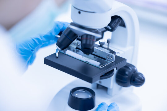 Scientist looking through a microscope in a laboratory