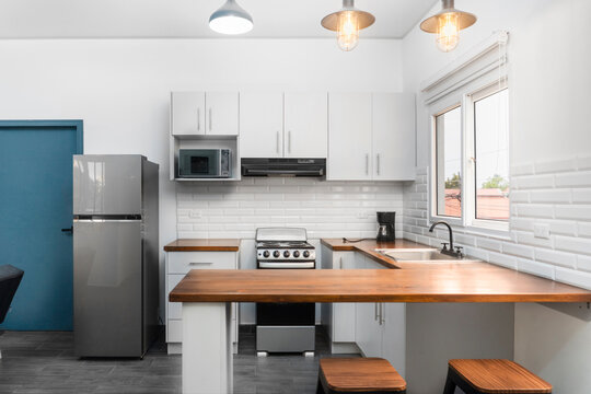 Modern kitchen interior with contemporary appliances and white cabinets