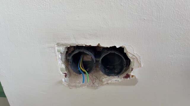 Exposed electrical wires. Wall socket hole. repair, replacement of sockets, electrical wiring. High quality 4k footage