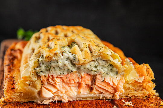 Salmon Wellington seafood lunch or dinner salmon en cro&ucirc;te fish in pastry tasty snack fresh, delicious, gourmet food background on the table  rustic food top view copy space