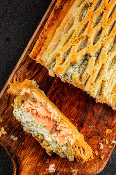 Salmon Wellington seafood lunch or dinner salmon en cro&ucirc;te fish in pastry tasty snack fresh, delicious, gourmet food background on the table  rustic food top view copy space