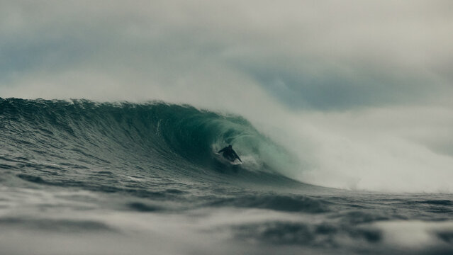 surfer and storm over the sea