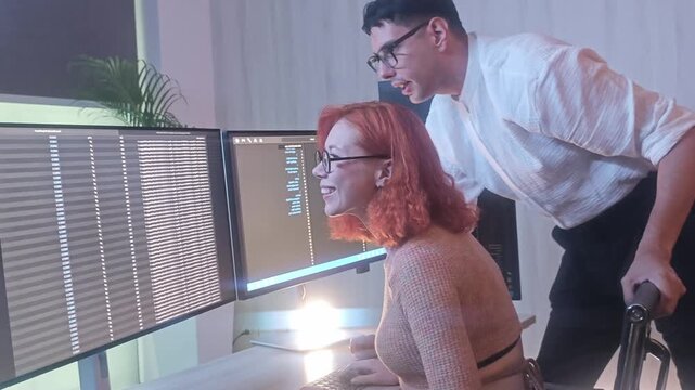Programmers working at night analyzing code on monitors in a modern office. Software developers collaborating on debugging cybersecurity and data programming projects. Ai coding Software technician.