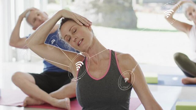 Yoga woman starting neck-to-overhead stretch, animating AR nodes tracking form as peers mirror