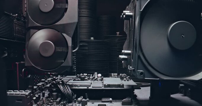 Working motherboards, graphic cards and fans. Camera move along components.