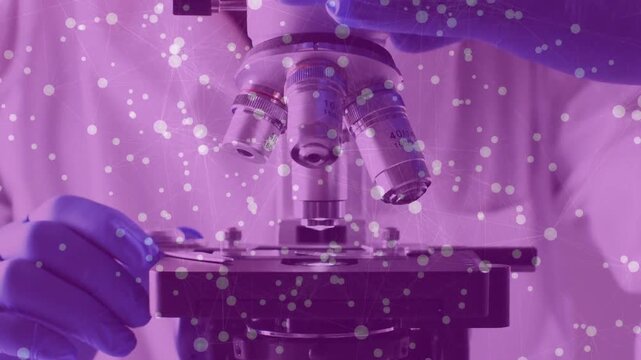 Lab tech reaching gloved hand, rotating turret aligning 40x objective, focusing, purple tint moving