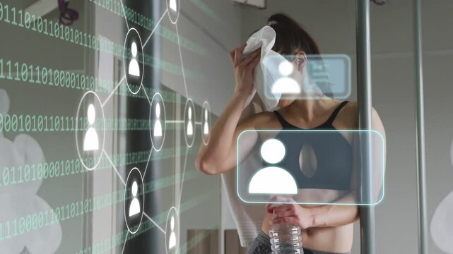 Post-workout cooling woman dabbing towel, holding bottle while AR overlay on mirror adding avatars