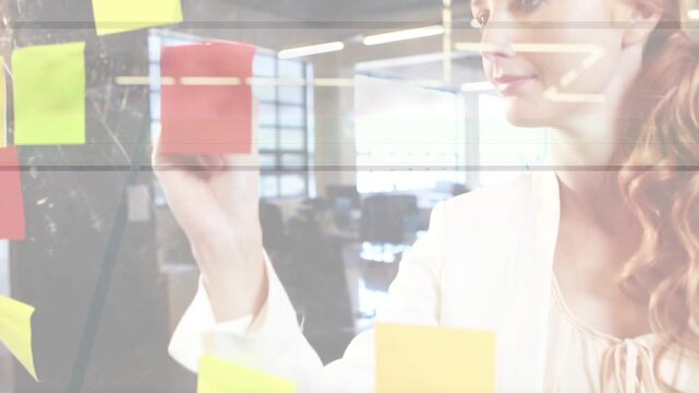Planner peeling note, placing notes on clear glass, writing with blue marker business planning