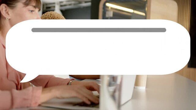 Coworkers typing on laptops in tech hub, input causing chat bubble expanding fading, alerting team