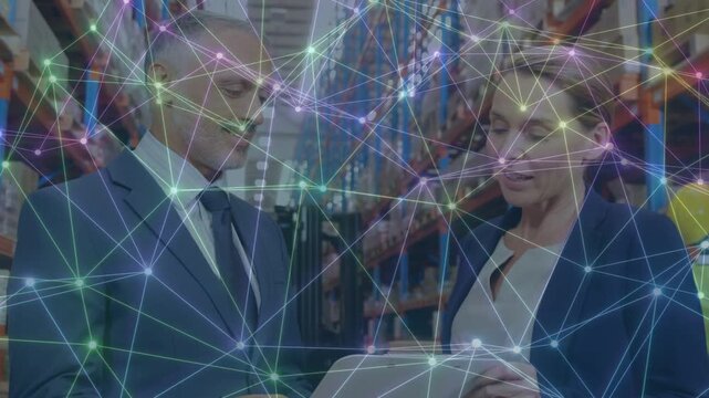 Man and woman in warehouse, woman scrolling tablet, network tracking stock, shaking hands agreeing