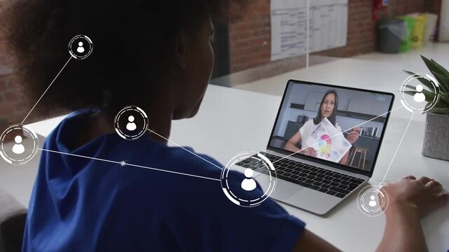 Woman watching laptop host pointing design color chart and causing network overlay on user and desk