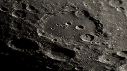 A photo of the lunar surface through an amateur telescope. The lunar surface is pockmarked with craters. © Sergei