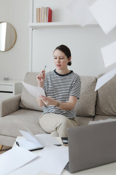 Creative photo of a busy business woman working with documents at workplace in a modern office. office manager or freelancer in a stylish room.