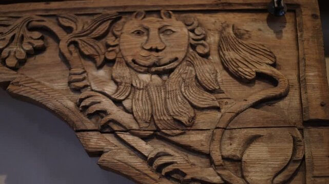 A wooden figurine of a man with a long beard, carved in intricate detail