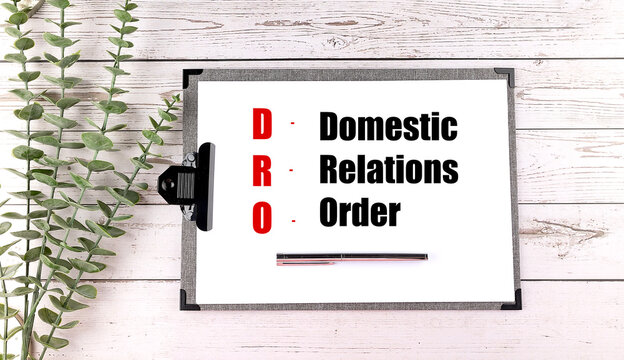 Domestic relations order concept with clipboard and pen on wooden desk representing legal agreement divorce settlement