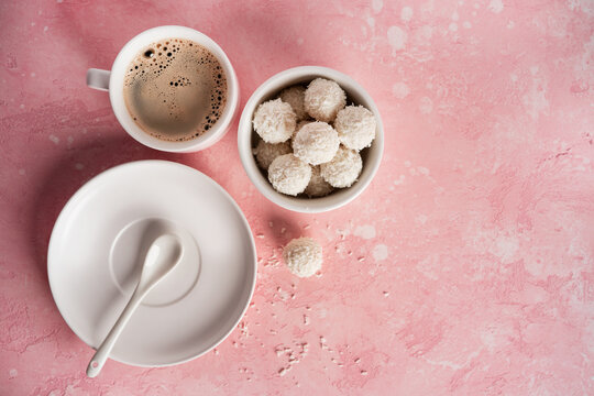 Coconut candies with nuts on pink background. Raffaello
