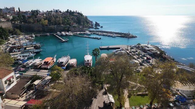 Aerial panoramic view of historic kaleici old town marina with traditional boats fortress walls in antalya turkey.