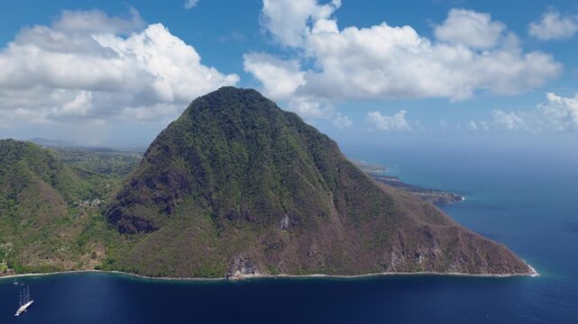 Breathtaking aerial drone footage captures majestic Piton volcanic peak rising from deep blue Caribbean waters in Saint Lucia.