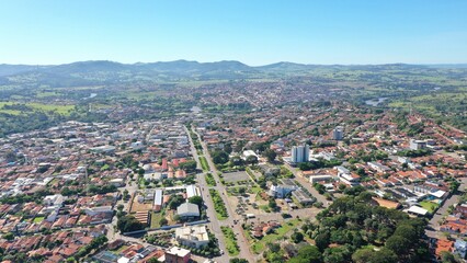 Fototapeta premium Aerial view of town of Ceres surrounded by mountains and green valleys on May, 2026. Ceres, Goias, Brazil