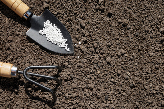 Gardening Tools with Ammonium Nitrate on Soil Surface