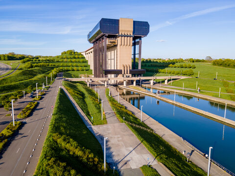 Aerial side angle of canal boat lift connecting upper and lower waterway basins at different levels, engineering solution for terrain elevation in inland barge transport and green logistics network