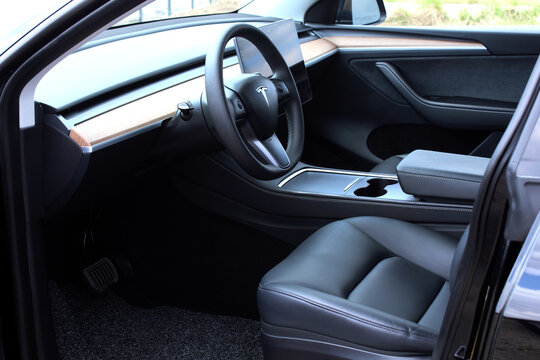 Vinnytsia, Ukraine; May 2, 2026. Black Tesla Y driver seat with steering wheel. Electric car Tesla Y dashboard. Premium electric car Tesla Y black leather interior.