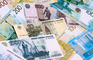 Obraz premium Russian ruble money bills pile on table. Russia banknotes of RUB currency close up.
