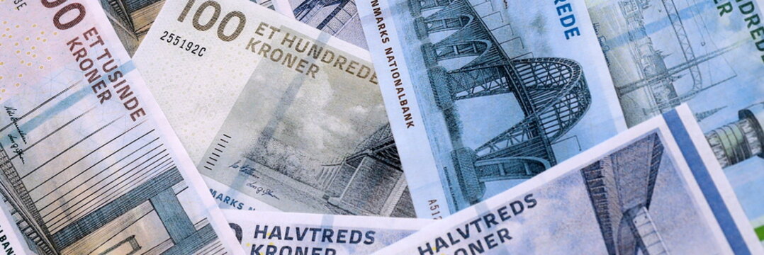 Danish krone money bills pile on table. Denmark banknotes of DKK currency close up.