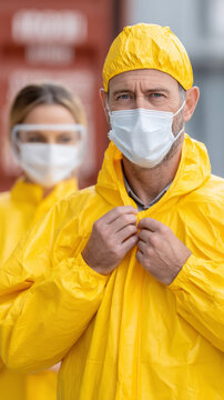 Caucasian adults in yellow protective gear and masks focusing on safety