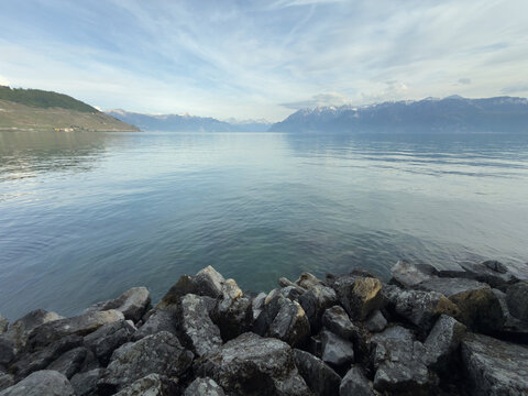 Rocky Stones in the Foreground Framing a Scenic Swiss Lake With Alpine Mountains Beyond