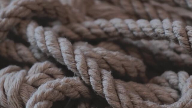 A stack of ropes rests on a table, possibly for storage or use