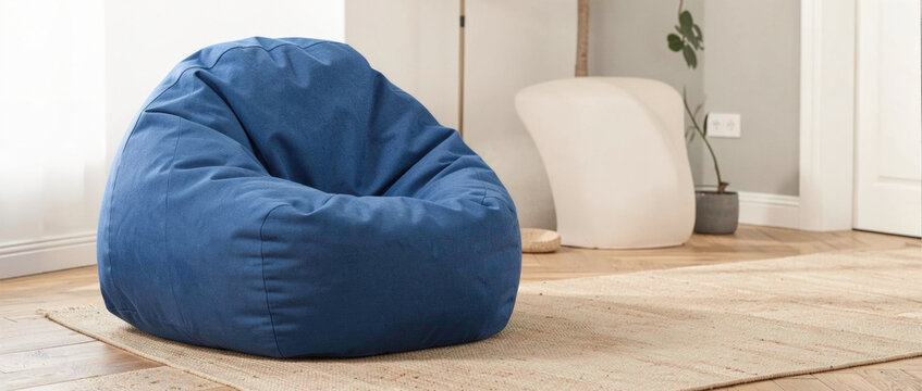 A blue bean bag chair sitting on top of a wooden floor, perfect for cozying up with a book or relaxing in style