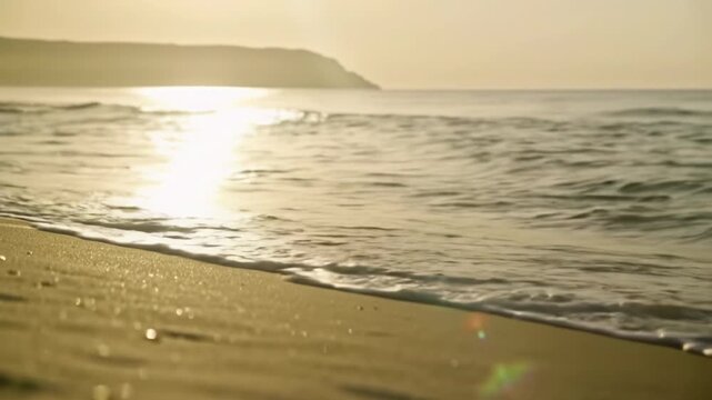 Expansive, serene golden sandy beach at tranquil golden hour, with gentle foamy waves washing ashore. A slow steadicam dolly video pushes into the ocean, highlighting shimmering wet sand and subtle