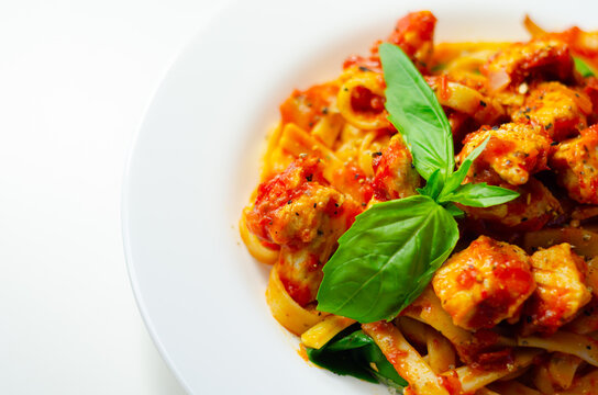 Fresh pasta with savory sauce and basil garnish