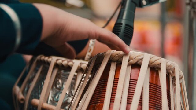 Indian tabla drums being played by a musician during the Holi festival