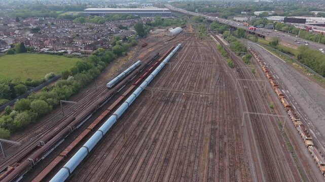 Aerial forward drone flight over multiple parallel railway tracks and rail network. Industrial transport, logistics and infrastructure concept.