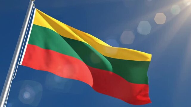 Lithuanian national flag waving on flagpole against blue sky