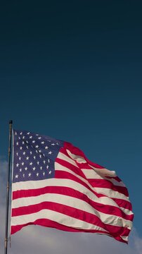 Vertical American Flag Waving In The Wind with Copy Space