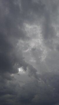 Gloomy weather scene. Overhead clouds signal brewing storm. Dark clouds form menacing storm shapes above. Intense atmospheric effects created by thick storm clouds overhead
