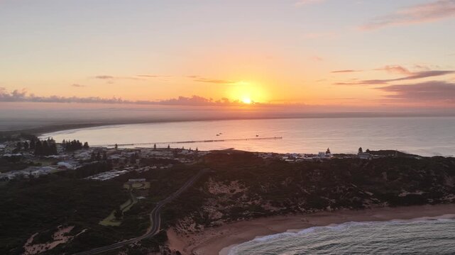 Beachport, South Australia at sunrise: 4K aerial drone footage of coastal town, jetty, calm ocean, Southern Ocean Beach and golden morning light