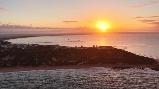 Beachport, South Australia at sunrise: 4K aerial drone footage of coastal town, jetty, calm ocean, Southern Ocean Beach and golden morning light
