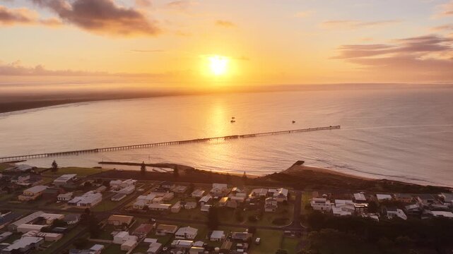 Beachport, South Australia at sunrise: 4K aerial drone footage of coastal town, jetty, calm ocean, Southern Ocean Beach and golden morning light