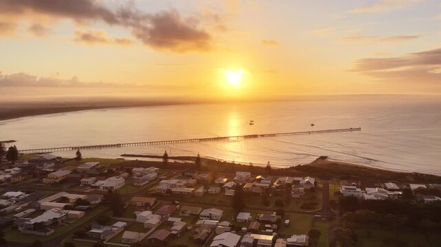 Beachport, South Australia at sunrise: 4K aerial drone footage of coastal town, jetty, calm ocean, Southern Ocean Beach and golden morning light
