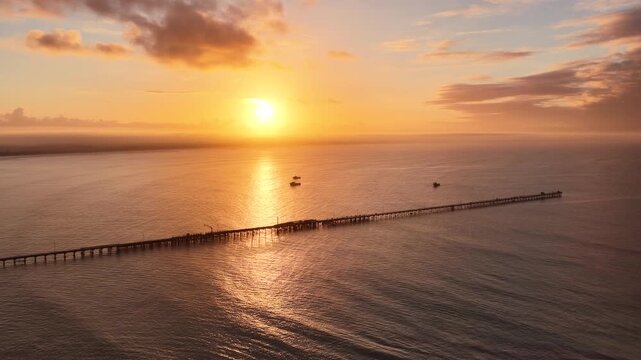 Beachport, South Australia at sunrise: 4K aerial drone footage of coastal town, jetty, calm ocean, Southern Ocean Beach and golden morning light