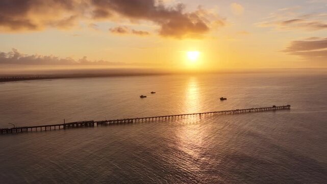 Beachport, South Australia at sunrise: 4K aerial drone footage of coastal town, jetty, calm ocean, Southern Ocean Beach and golden morning light