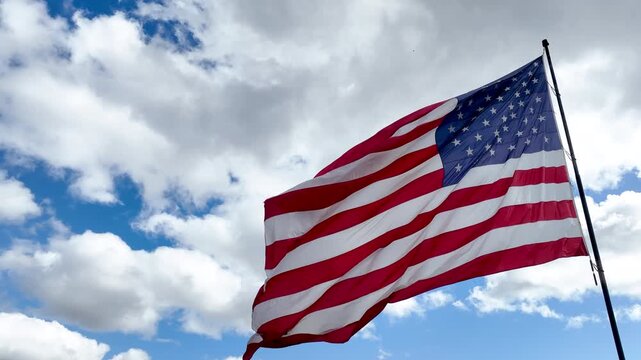 American Flag Blowing in Gentle Wind with Copy Space in Sky