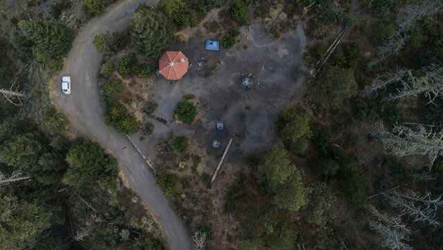 Aerial top view of a mountain campsite in Nevado de Colima, Mexico, camping logistics and forest clearing.
