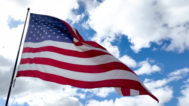 American Flag Flying on Flagpole with Bright Sky Background