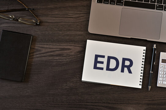 Secure technology and EDR on notebook with laptop, glasses, pen. Cyber security, protection and digital trust.
