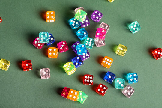 Colorful game dices on green background